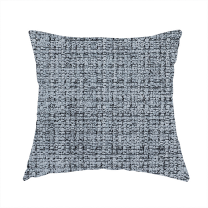 The fabric used to create these handmade cushions is a slate blue and grey textured boucle fabric with a dense, dimensional grid weave.