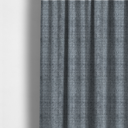 The fabric used to create these made-to-measure curtains is a slate blue and grey textured boucle fabric with a dense, dimensional grid weave.
