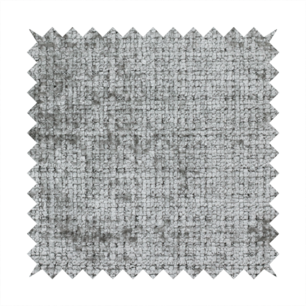 A silver-grey textured boucle fabric with a dimensional grid weave and mottled grey accents.