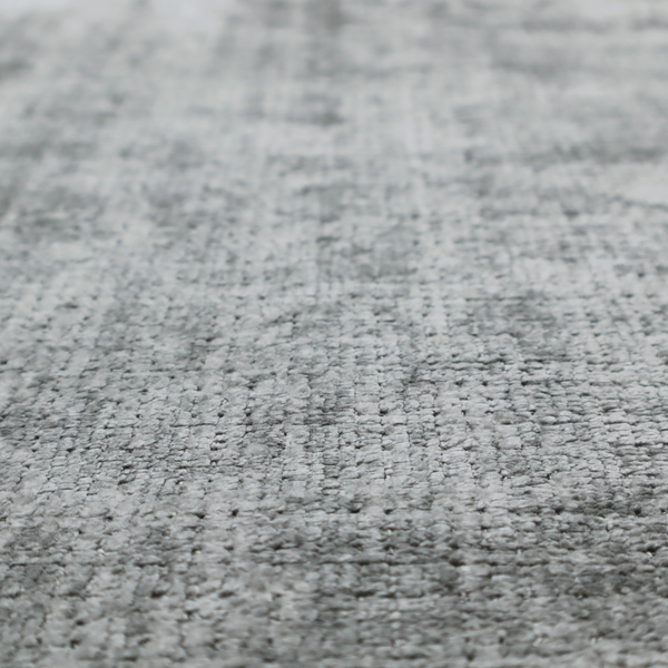 A silver-grey textured boucle fabric with a dimensional grid weave and mottled grey accents.