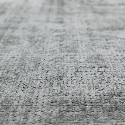 A silver-grey textured boucle fabric with a dimensional grid weave and mottled grey accents.