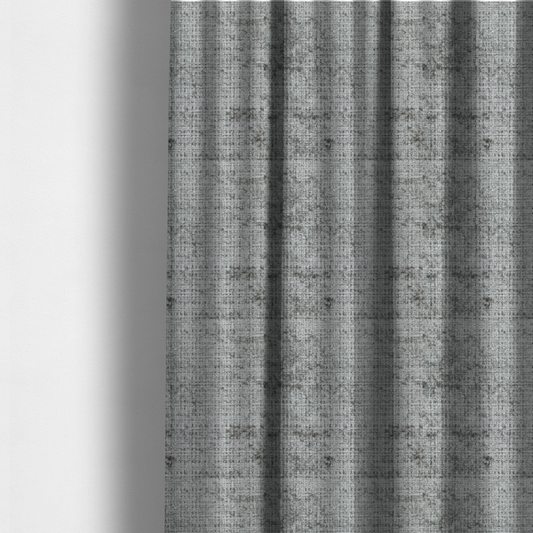 The fabric used to create these made-to-measure curtains is a silver-grey textured boucle fabric with a dimensional grid weave and mottled grey accents.