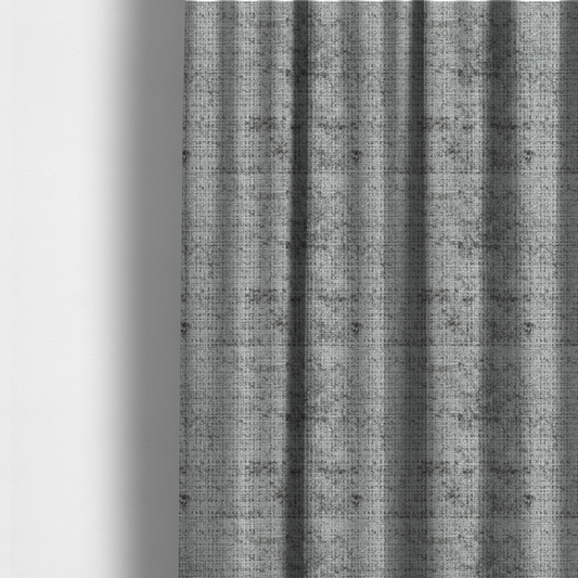 The fabric used to create these made-to-measure curtains is a silver-grey textured boucle fabric with a dimensional grid weave and mottled grey accents.