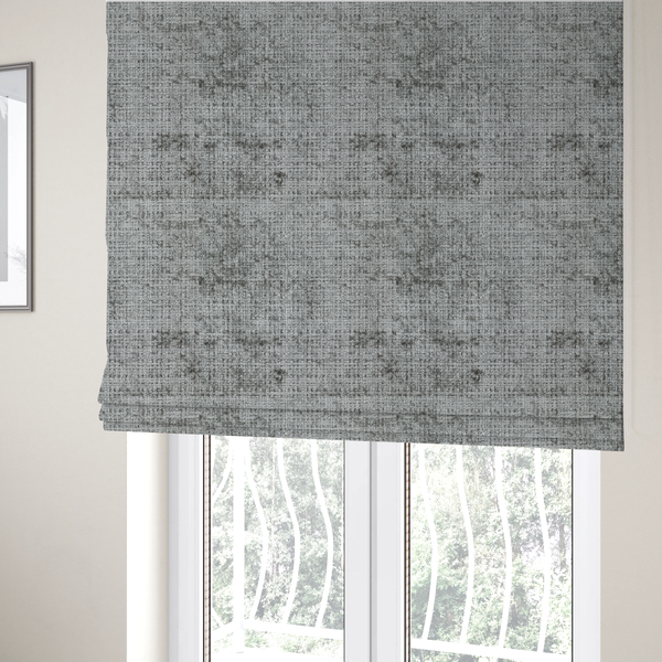 The fabric used to create these Roman blinds is a silver-grey textured boucle fabric with a dimensional grid weave and mottled grey accents.