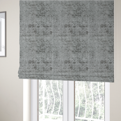 The fabric used to create these Roman blinds is a silver-grey textured boucle fabric with a dimensional grid weave and mottled grey accents.