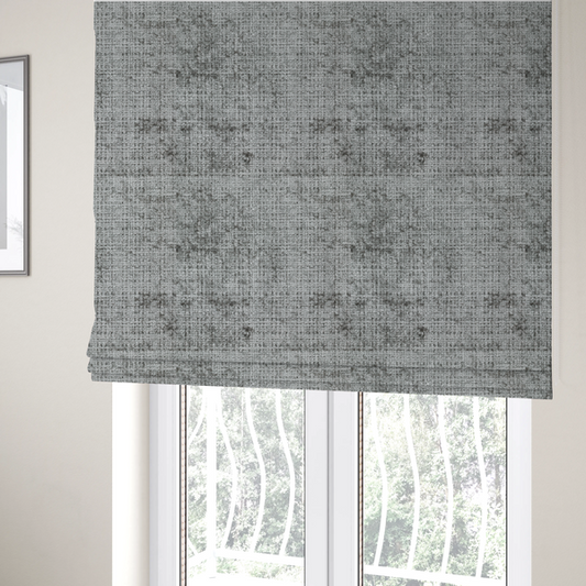 The fabric used to create these Roman blinds is a silver-grey textured boucle fabric with a dimensional grid weave and mottled grey accents.