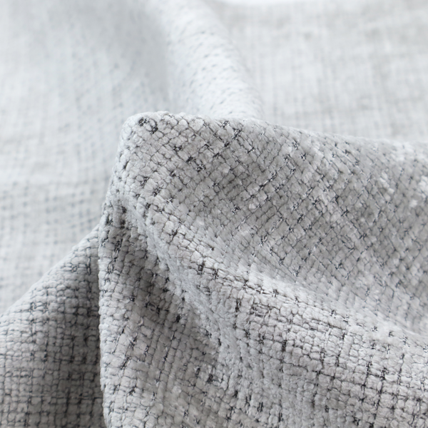 A light grey upholstery fabric. This material features a dense boucle texture with a prominent architectural grid pattern. The weave combines pale grey and charcoal-flecked yarns, creating a sophisticated, salt-and-pepper dimensional effect.
