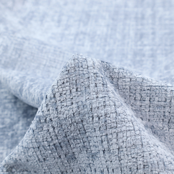 A Scanno weave upholstery fabric in an Ice Blue shade, featuring a textured, woven pattern with small, grid-like interlocking threads.