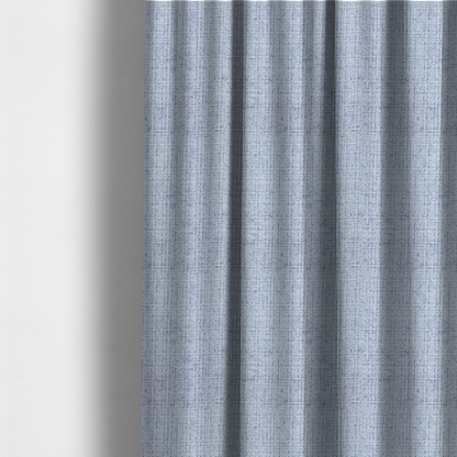 The fabric used to create these made-to-measure curtains is a Scanno weave upholstery fabric in an Ice Blue shade, featuring a textured, woven pattern with small, grid-like interlocking threads.