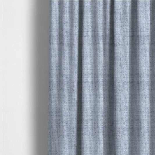 The fabric used to create these made-to-measure curtains is a Scanno weave upholstery fabric in an Ice Blue shade, featuring a textured, woven pattern with small, grid-like interlocking threads.
