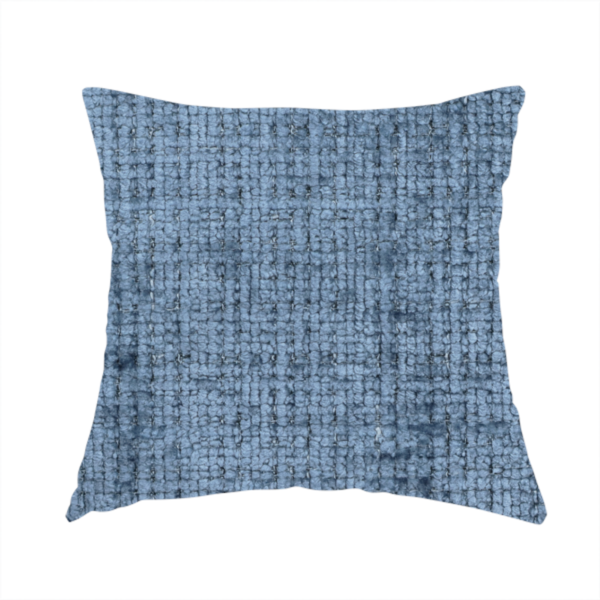The fabric used to create these handmade cushions is a Scanno Weave upholstery fabric in a medium blue shade, featuring a detailed, woven texture with an interlocking grid pattern.