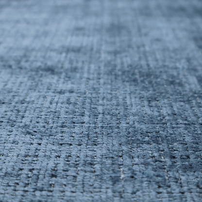 Scanno Weave upholstery fabric in a medium blue shade, featuring a detailed, woven texture with an interlocking grid pattern.