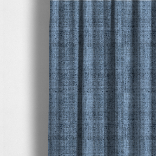 The fabric used to create these made-to-measure curtains is a Scanno Weave upholstery fabric in a medium blue shade, featuring a detailed, woven texture with an interlocking grid pattern.
