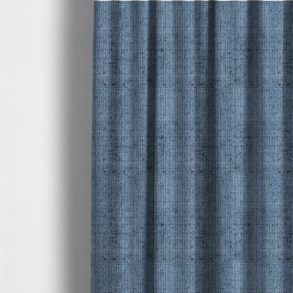 The fabric used to create these made-to-measure curtains is a Scanno Weave upholstery fabric in a medium blue shade, featuring a detailed, woven texture with an interlocking grid pattern.