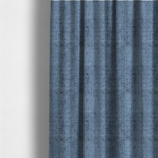 The fabric used to create these made-to-measure curtains is a Scanno Weave upholstery fabric in a medium blue shade, featuring a detailed, woven texture with an interlocking grid pattern.