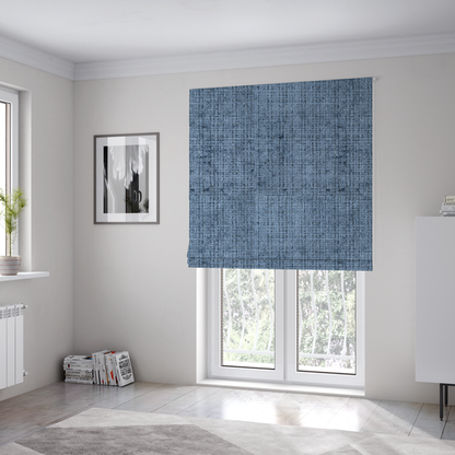 The fabric used to create these Roman blinds is a Scanno Weave upholstery fabric in a medium blue shade, featuring a detailed, woven texture with an interlocking grid pattern.