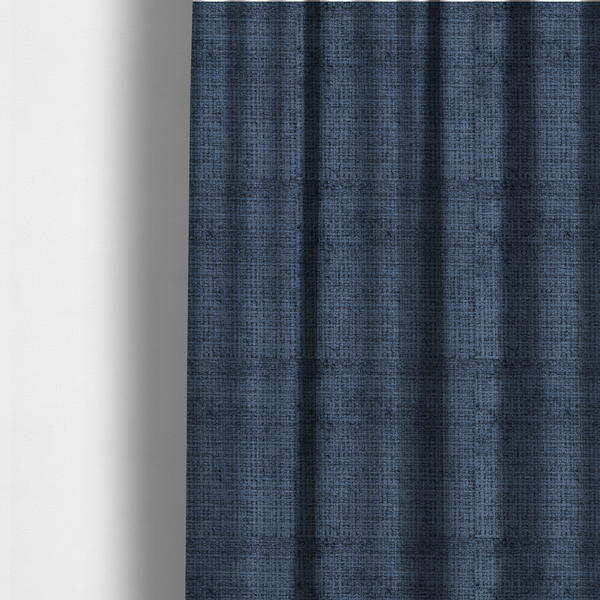 The fabric used to create these made-to-measure curtains is a Scanno Weave upholstery fabric in a deep, dark blue shade, showcasing a detailed, woven texture with an interlocking grid pattern.