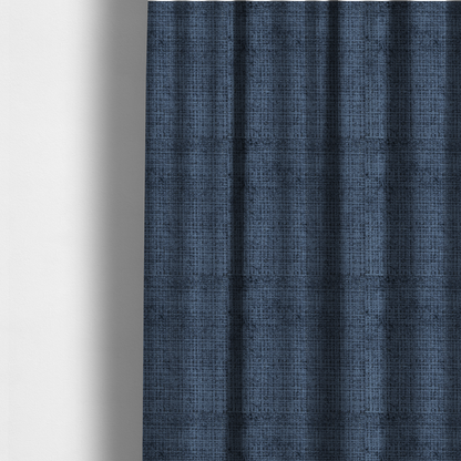 The fabric used to create these made-to-measure curtains is a Scanno Weave upholstery fabric in a deep, dark blue shade, showcasing a detailed, woven texture with an interlocking grid pattern.