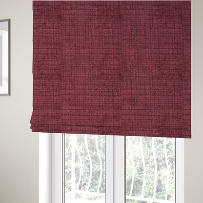 The fabric used to create these Roman blinds is a Scanno Weave upholstery fabric in a deep red shade, showcasing a detailed, woven texture with an interlocking grid pattern.