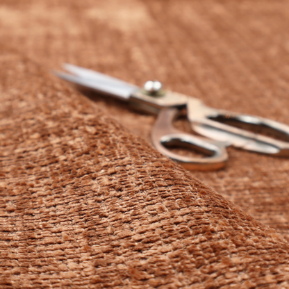 Scanno Weave upholstery fabric in a warm tan shade, showcasing a detailed, woven texture with an interlocking grid pattern.