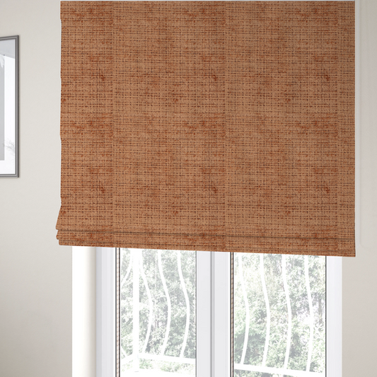 The fabric used to create these roman blinds is a Scanno Weave upholstery fabric in a warm tan shade, showcasing a detailed, woven texture with an interlocking grid pattern.