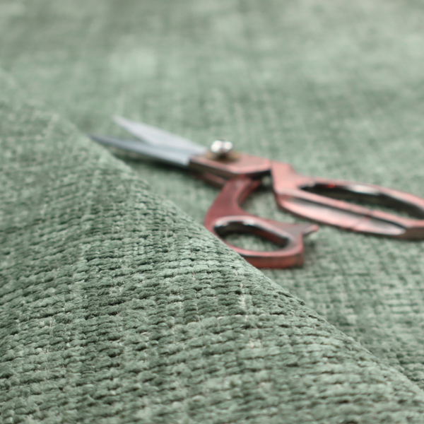 Scanno Weave upholstery fabric in a soft mint green shade, showcasing a detailed, woven texture with an interlocking grid pattern.