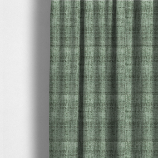 The fabric used to create these made-to-measure curtains is a Scanno Weave upholstery fabric in a soft mint green shade, showcasing a detailed, woven texture with an interlocking grid pattern.