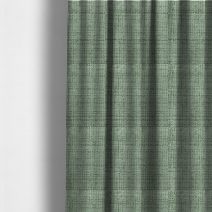 The fabric used to create these made-to-measure curtains is a Scanno Weave upholstery fabric in a soft mint green shade, showcasing a detailed, woven texture with an interlocking grid pattern.