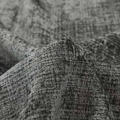 Scanno Weave upholstery fabric in a neutral grey shade, featuring a detailed, woven texture with an interlocking grid pattern.