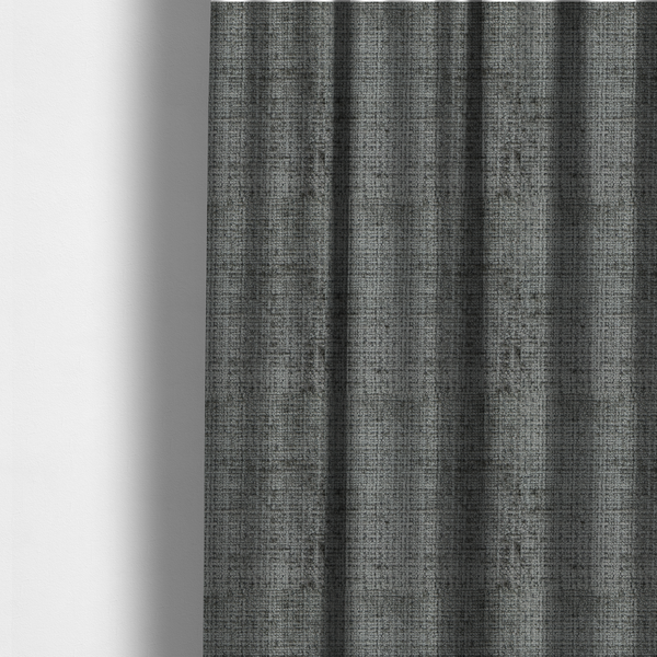 The fabric used to create these made-to-measure curtains is a Scanno Weave upholstery fabric in a neutral grey shade, featuring a detailed, woven texture with an interlocking grid pattern.