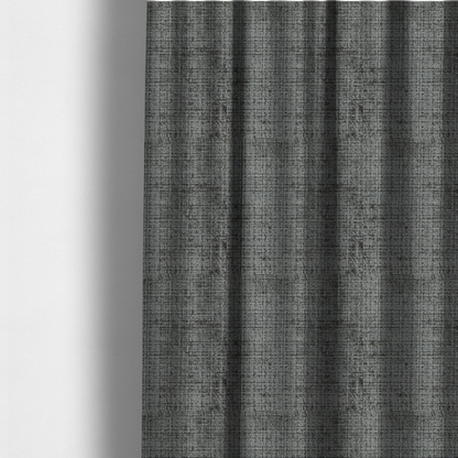 The fabric used to create these made-to-measure curtains is a Scanno Weave upholstery fabric in a neutral grey shade, featuring a detailed, woven texture with an interlocking grid pattern.