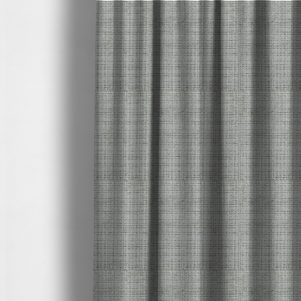 The fabric used to create these made-to-measure curtains is a Scanno Weave upholstery fabric in a light grey shade, featuring a detailed, woven texture with an interlocking grid pattern.