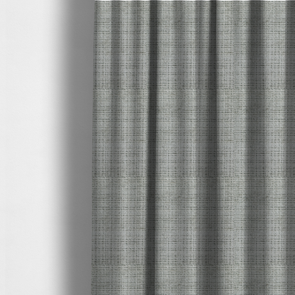 The fabric used to create these made-to-measure curtains is a Scanno Weave upholstery fabric in a light grey shade, featuring a detailed, woven texture with an interlocking grid pattern.