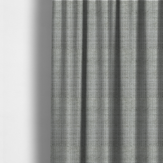 The fabric used to create these made-to-measure curtains is a Scanno Weave upholstery fabric in a light grey shade, featuring a detailed, woven texture with an interlocking grid pattern.