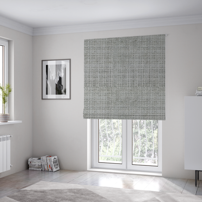 The fabric used to create these Roman blinds is a Scanno Weave upholstery fabric in a light grey shade, featuring a detailed, woven texture with an interlocking grid pattern.