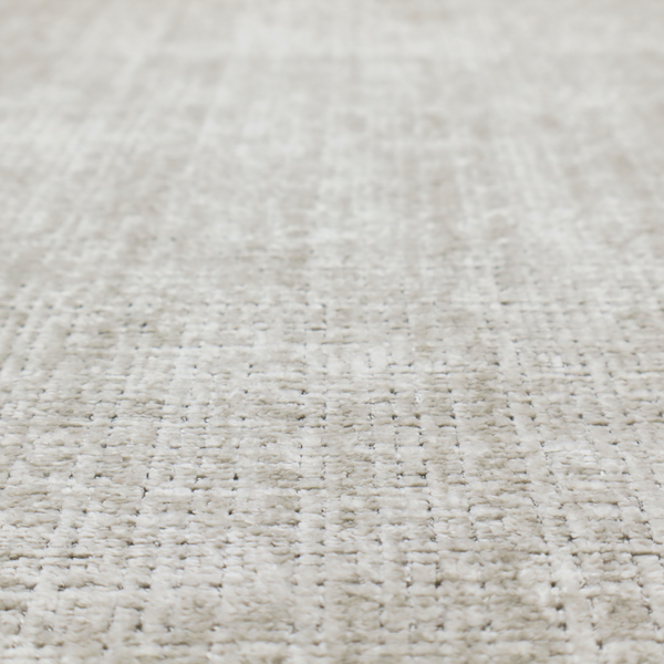 Scanno Weave upholstery fabric in a creamy off-white shade, featuring a detailed, woven texture with an interlocking grid pattern.