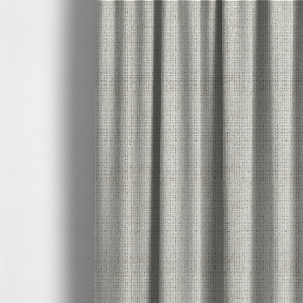 The fabric used to create these made-to-measure curtains is a Scanno Weave upholstery fabric in a creamy off-white shade, featuring a detailed, woven texture with an interlocking grid pattern.