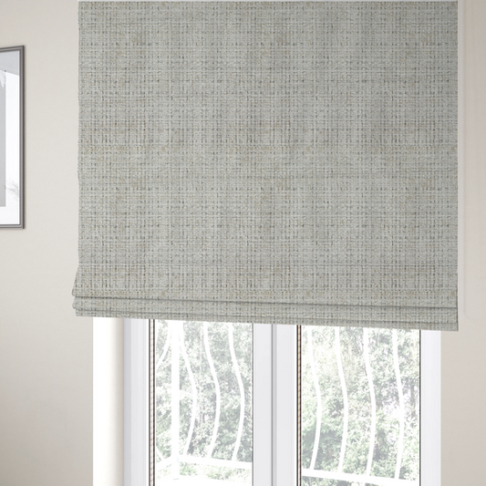 The fabric used to create these Roman blinds is a Scanno Weave upholstery fabric in a creamy off-white shade, featuring a detailed, woven texture with an interlocking grid pattern.