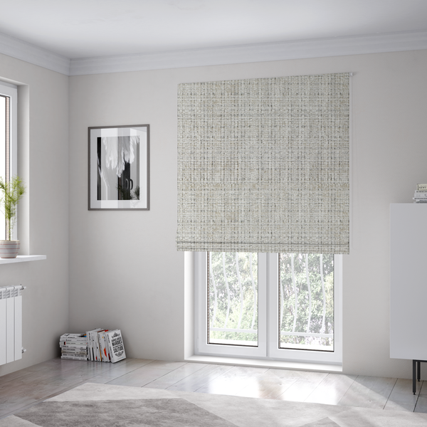 The fabric used to create these Roman blinds is a Scanno Weave upholstery fabric in a creamy off-white shade, featuring a detailed, woven texture with an interlocking grid pattern.