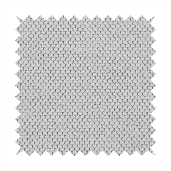 A waffle-knit or honeycomb-patterned weave characterized by a repeating, three-dimensional grid of soft, raised textures. Its off-white or light grey tone and uniform geometric structure suggest a cosy, high-quality material, commonly found in thermal apparel, heavy cotton blankets, or sophisticated upholstery. The dense, woven design provides a matte appearance with a subtle, visually rich depth.