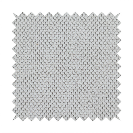 A waffle-knit or honeycomb-patterned weave characterized by a repeating, three-dimensional grid of soft, raised textures. Its off-white or light grey tone and uniform geometric structure suggest a cosy, high-quality material, commonly found in thermal apparel, heavy cotton blankets, or sophisticated upholstery. The dense, woven design provides a matte appearance with a subtle, visually rich depth.