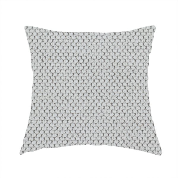The fabric used to create these handmade cushions is a waffle-knit or honeycomb-patterned weave characterized by a repeating, three-dimensional grid of soft, raised textures. Its off-white or light grey tone and uniform geometric structure suggest a cosy, high-quality material, commonly found in thermal apparel, heavy cotton blankets, or sophisticated upholstery. The dense, woven design provides a matte appearance with a subtle, visually rich depth.