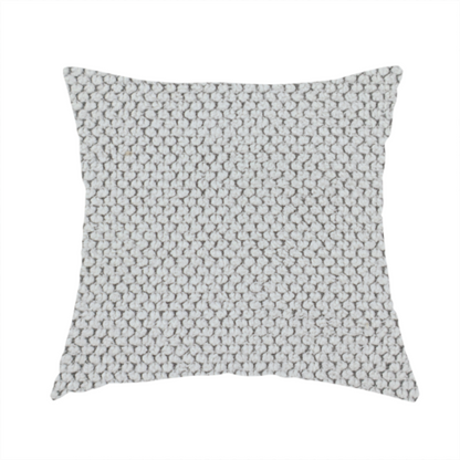 The fabric used to create these handmade cushions is a waffle-knit or honeycomb-patterned weave characterized by a repeating, three-dimensional grid of soft, raised textures. Its off-white or light grey tone and uniform geometric structure suggest a cosy, high-quality material, commonly found in thermal apparel, heavy cotton blankets, or sophisticated upholstery. The dense, woven design provides a matte appearance with a subtle, visually rich depth.