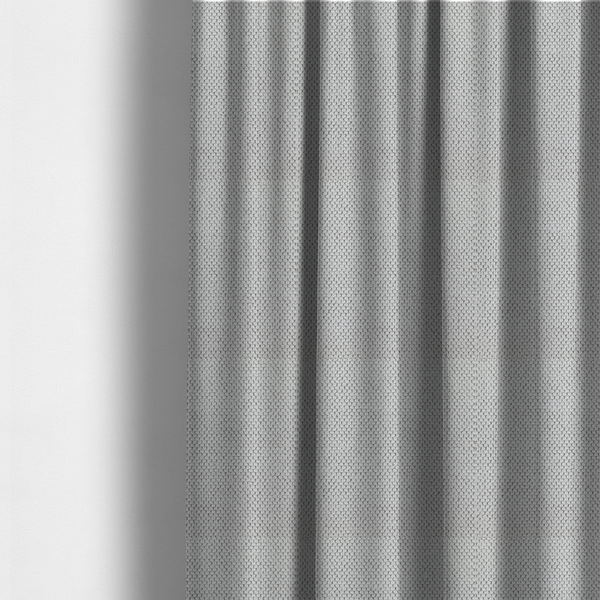 The fabric used to create these made-to-measure curtains is a waffle-knit or honeycomb-patterned weave characterized by a repeating, three-dimensional grid of soft, raised textures. Its off-white or light grey tone and uniform geometric structure suggest a cosy, high-quality material, commonly found in thermal apparel, heavy cotton blankets, or sophisticated upholstery. The dense, woven design provides a matte appearance with a subtle, visually rich depth.