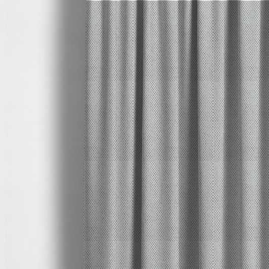 The fabric used to create these made-to-measure curtains is a waffle-knit or honeycomb-patterned weave characterized by a repeating, three-dimensional grid of soft, raised textures. Its off-white or light grey tone and uniform geometric structure suggest a cosy, high-quality material, commonly found in thermal apparel, heavy cotton blankets, or sophisticated upholstery. The dense, woven design provides a matte appearance with a subtle, visually rich depth.