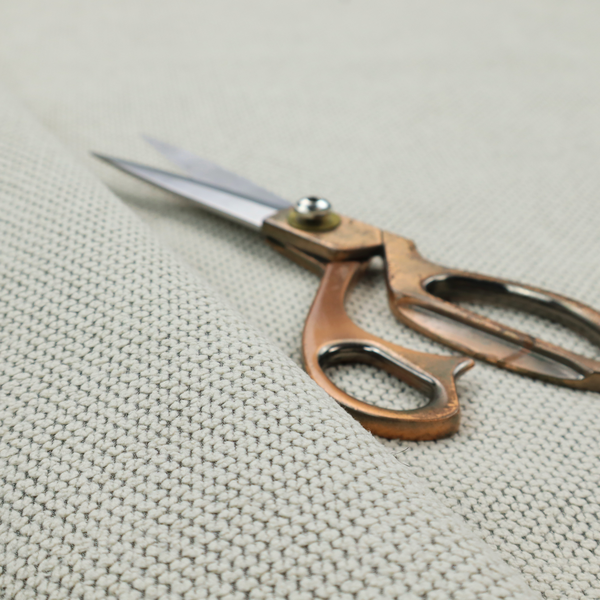 A waffle-knit or honeycomb-patterned weave, defined by a uniform, three-dimensional grid of raised, rounded textures. Its classic, versatile ivory hue and matte finish provide an elegant, cosy aesthetic. This structured, high-quality material is an excellent choice for luxury upholstery, decorative cushions, and premium home textiles that require a blend of durability and timeless style.