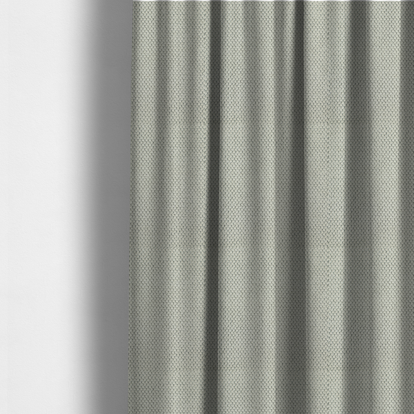 The fabric used to create these made-to-measure curtains is a waffle-knit or honeycomb-patterned weave, defined by a uniform, three-dimensional grid of raised, rounded textures. Its classic, versatile ivory hue and matte finish provide an elegant, cosy aesthetic. This structured, high-quality material is an excellent choice for luxury upholstery, decorative cushions, and premium home textiles that require a blend of durability and timeless style.