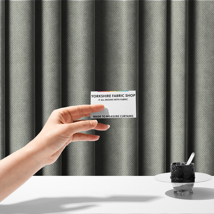 The fabric used to create these made-to-measure curtains is a waffle-knit or honeycomb-patterned weave, defined by a uniform, three-dimensional grid of raised, rounded textures. Its classic, versatile ivory hue and matte finish provide an elegant, cosy aesthetic. This structured, high-quality material is an excellent choice for luxury upholstery, decorative cushions, and premium home textiles that require a blend of durability and timeless style.