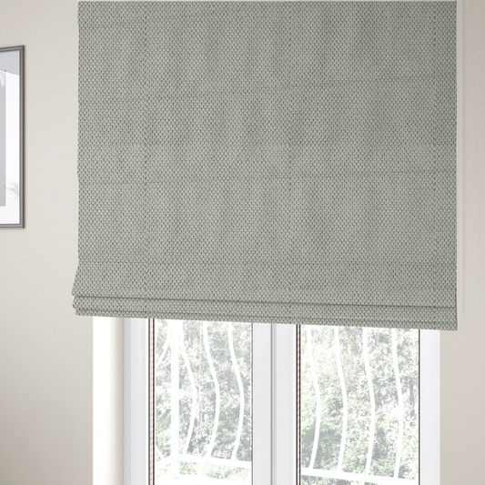 The fabric used to create these Roman blinds is a waffle-knit or honeycomb-patterned weave, defined by a uniform, three-dimensional grid of raised, rounded textures. Its classic, versatile ivory hue and matte finish provide an elegant, cosy aesthetic. This structured, high-quality material is an excellent choice for luxury upholstery, decorative cushions, and premium home textiles that require a blend of durability and timeless style.