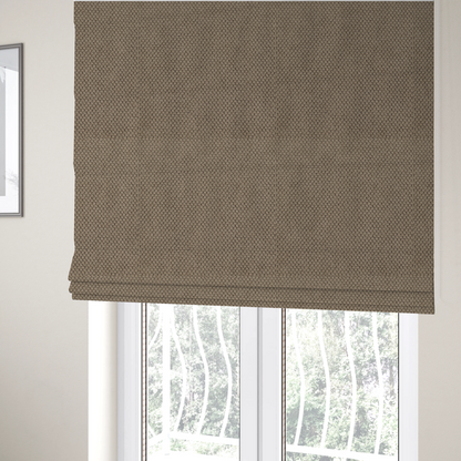 The fabric used to create these Roman blinds is a waffle-knit or honeycomb-patterned weave, defined by a uniform, three-dimensional grid of raised, rounded textures. Its rich, earthy taupe or warm brown hue and matte finish provide an elegant, cosy aesthetic. This structured, high-quality material is an excellent choice for luxury upholstery, decorative cushions, and premium home textiles that require a blend of durability and timeless style.